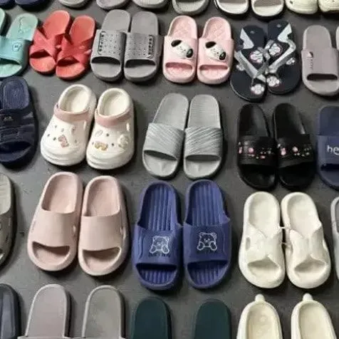 Second-hand children's sandals bales from RossBoss, featuring various colors like pink, blue, white, and grey, with different designs including cartoon characters and patterns, available for wholesale export.