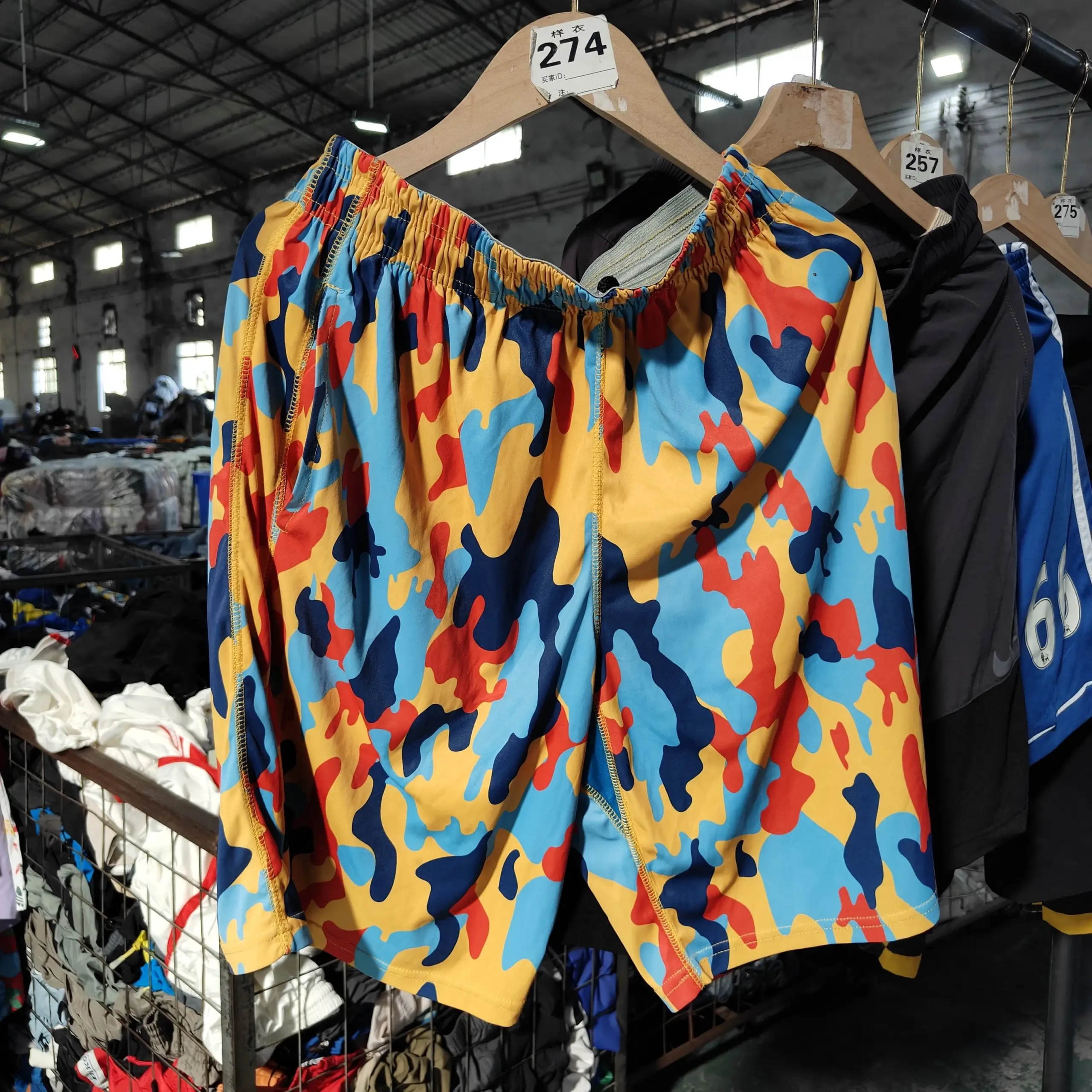 Camouflage shorts with yellow, blue, red, and black patterns.