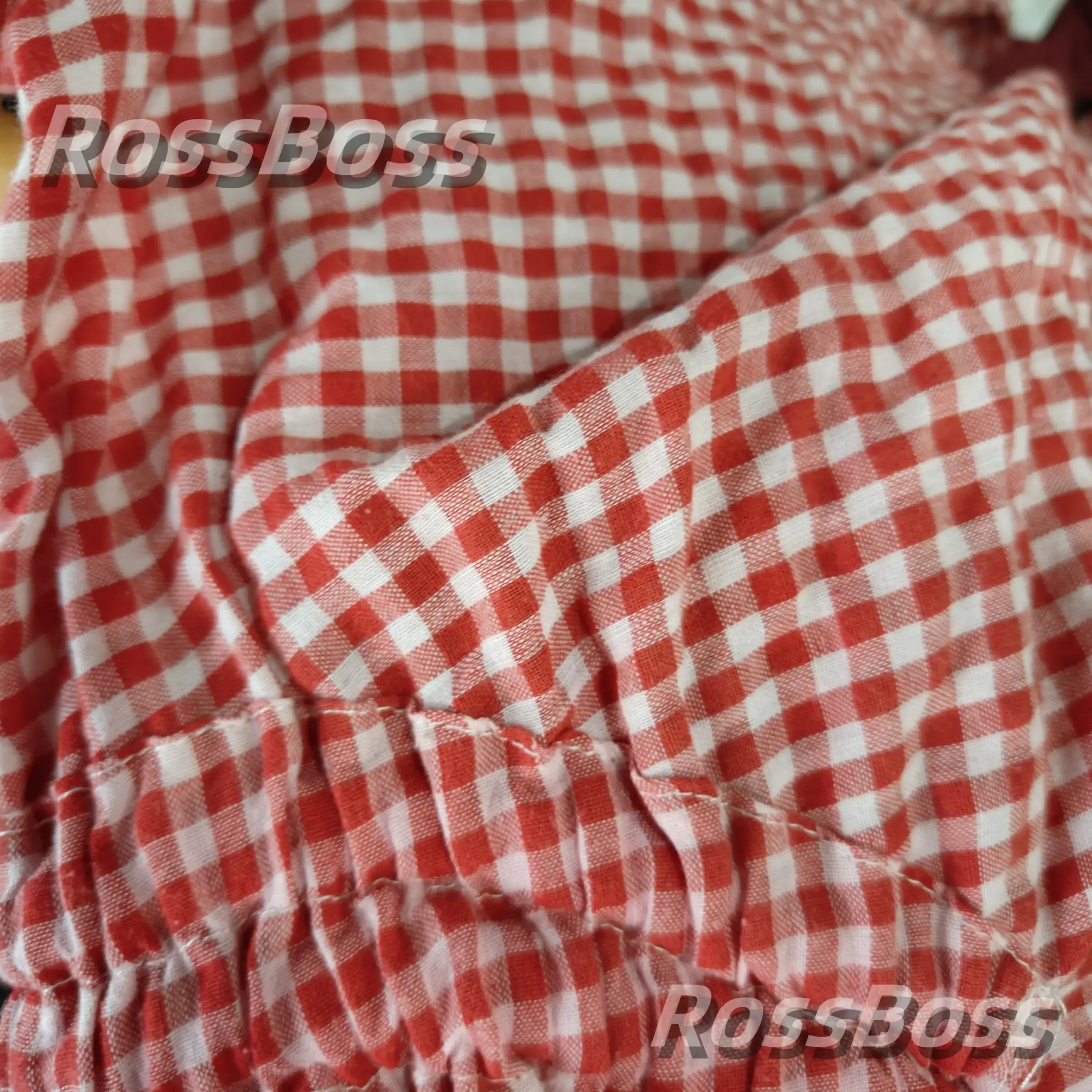 Red and white checkered shirt fabric with elastic cuffs.