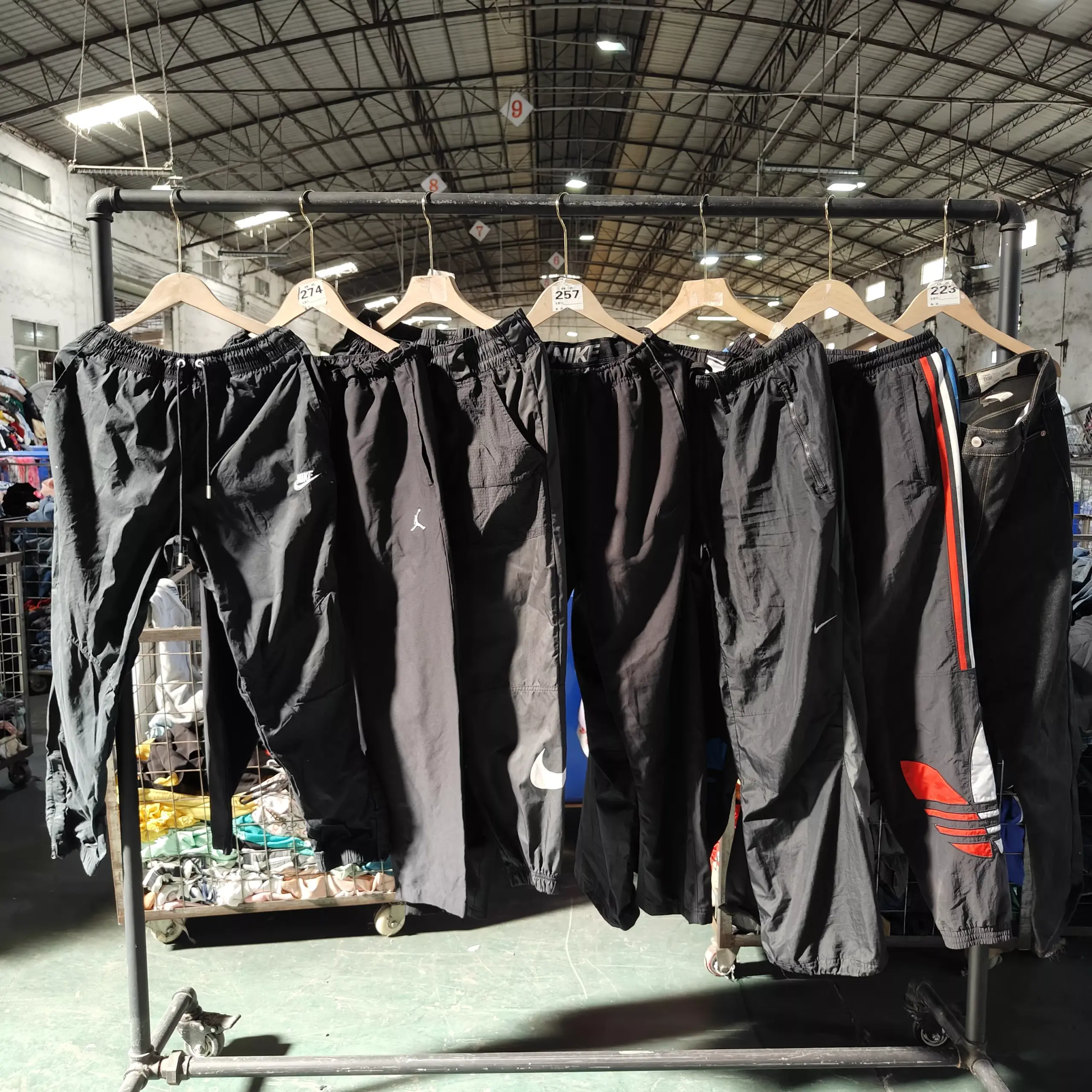 Nike black sportswear pants on hangers