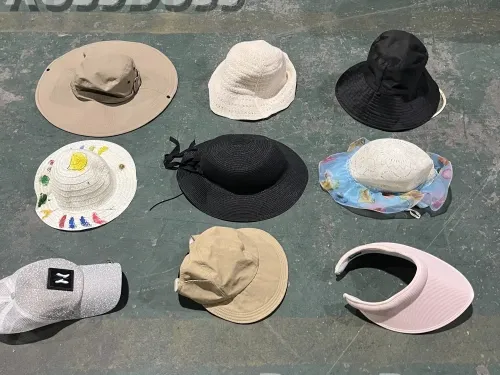 Sun hats and visors in various colors and styles, including beige, black, white, and pink, available for wholesale from RossBoss, a factory-direct supplier of used clothing and accessories.
