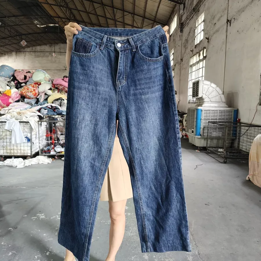 Blue denim jeans with a classic five-pocket design, suitable for both casual wear and wholesale distribution.