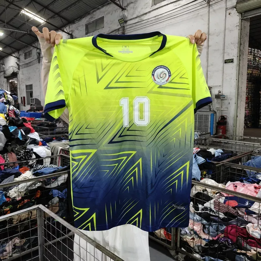Yellow and blue gradient sports jersey with number 10, featuring dynamic patterns and a circular logo on the left chest area.