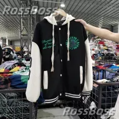 Black and white varsity jacket with green logo on the chest.