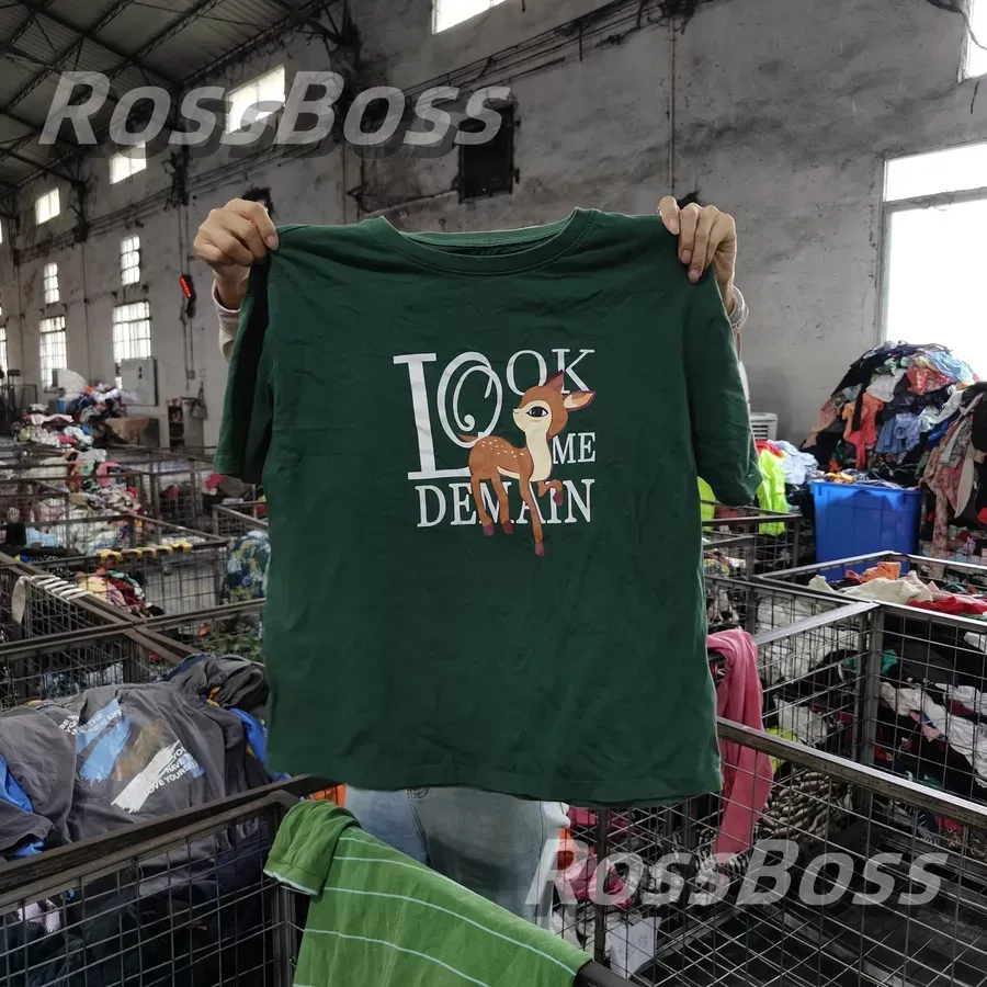 Green t-shirt with "Look Me Demain" text and deer graphic, part of RossBoss's used branded clothes wholesale offerings.