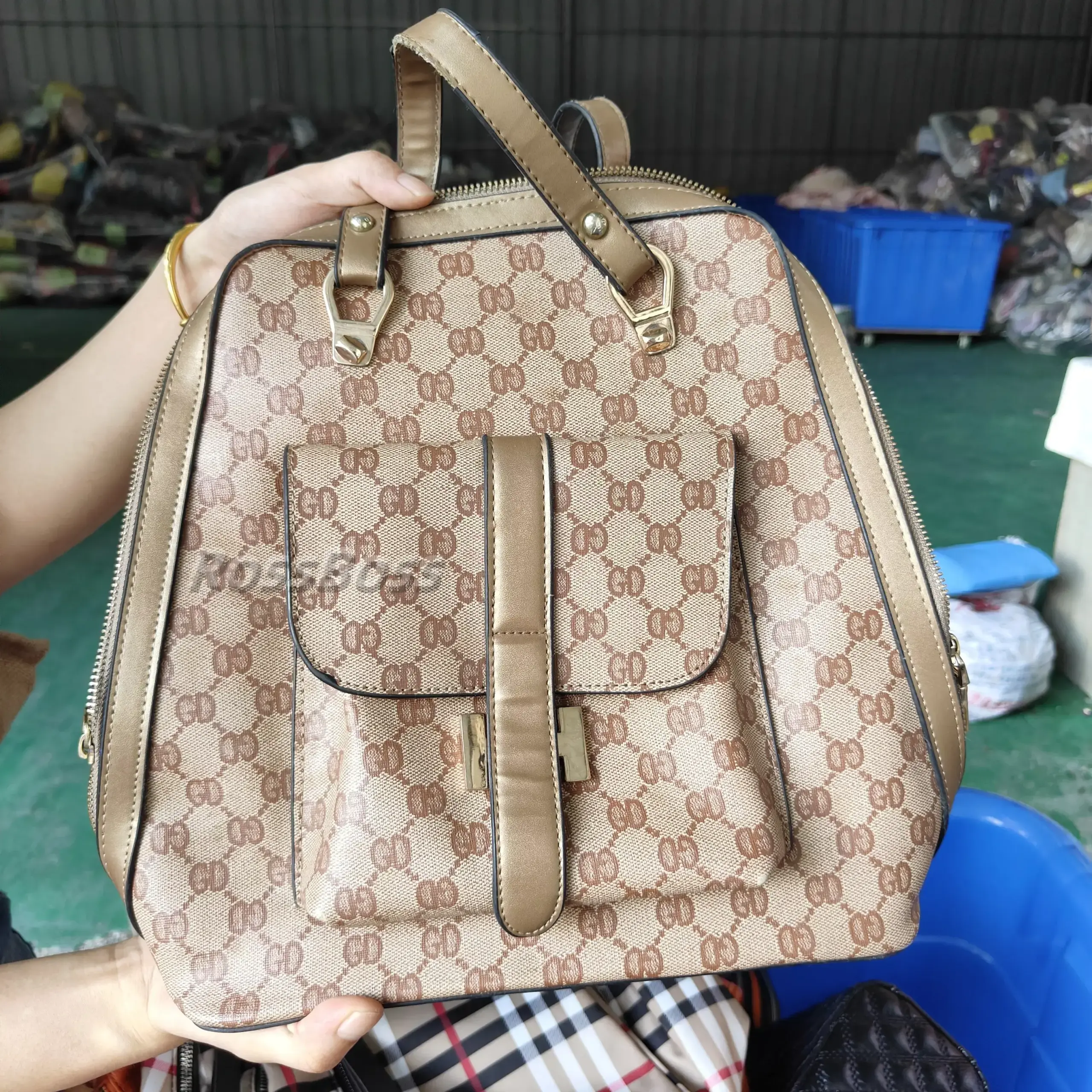 Brown leather backpack with gold-tone hardware and monogram pattern.