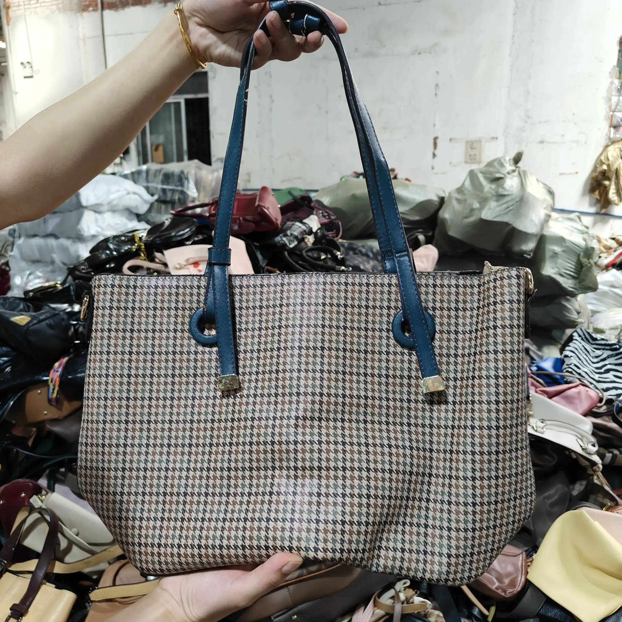 Houndstooth patterned ladies' bag with blue straps