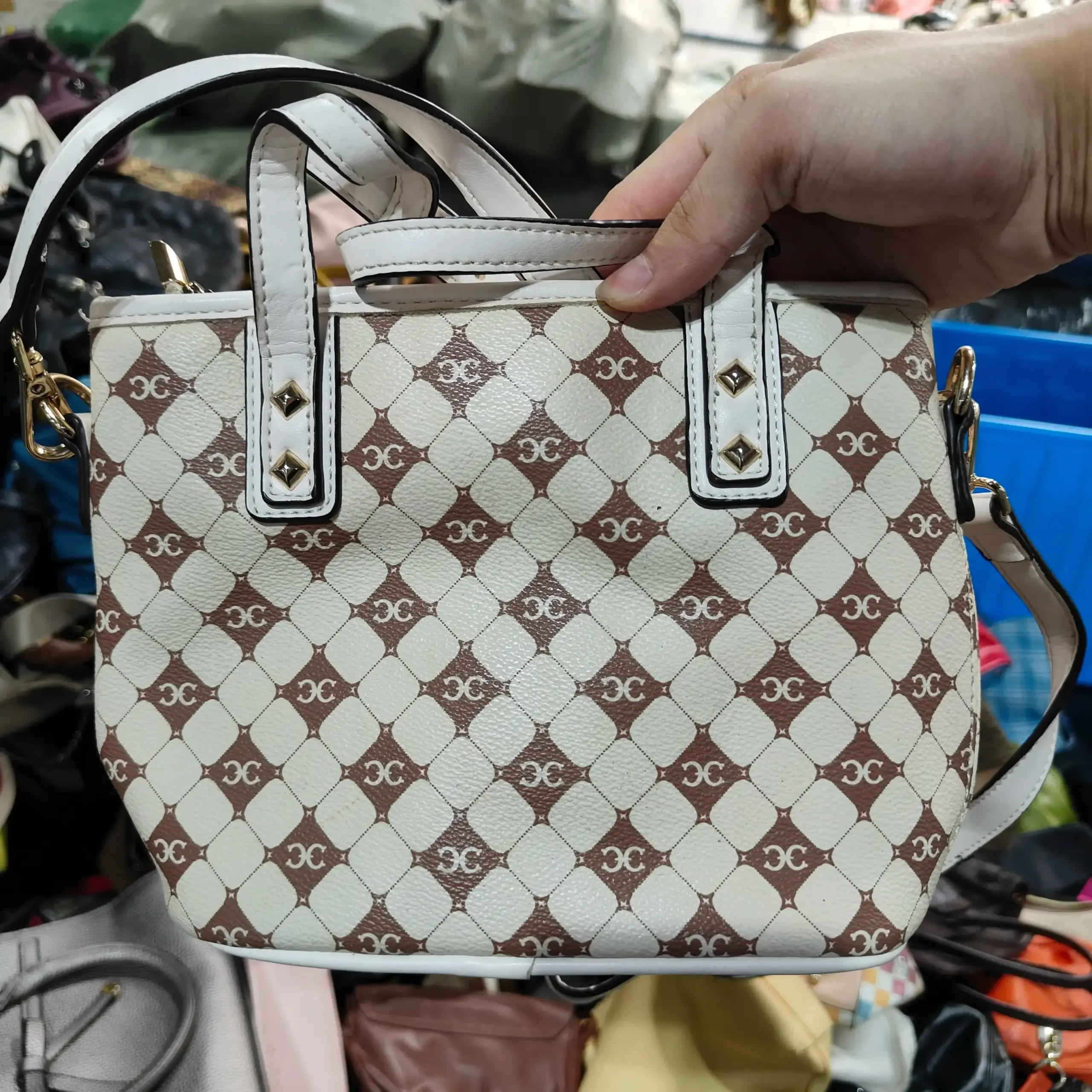 White and brown patterned leather bag with gold hardware