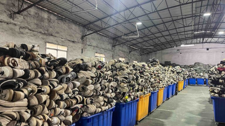 Sorted second-hand footwear and mixed shoes staged for product-specific packing